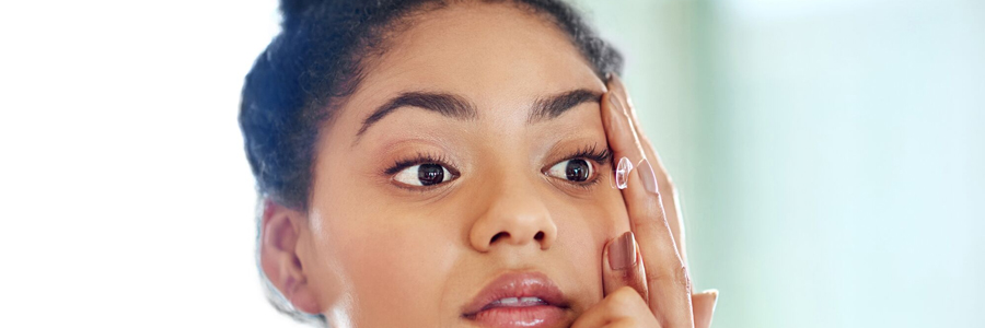 Woman putting in contact lenses