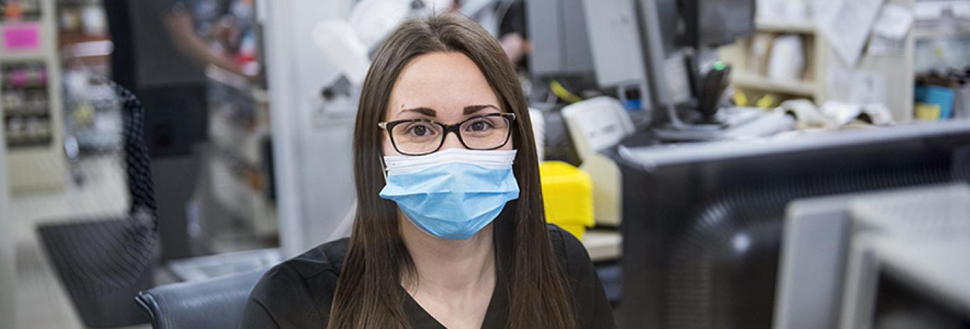 Friendly pharmacy tech serves customers at Chandler Retail Pharmacy