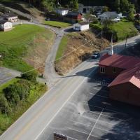 An aerial shot of a small two-lane road in Phelps, Ky. Logan Hillerman's State Police SUV is visible in the top of the photo, driving toward the bottom.